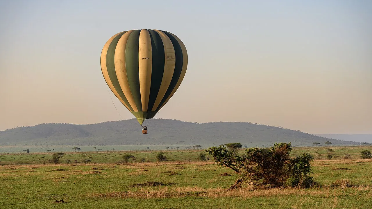 Serengeti Balloon tour heading in for landing just after sunrise. The basket holds 16 people plus the pilot, to give an idea of how massive these balloons are.