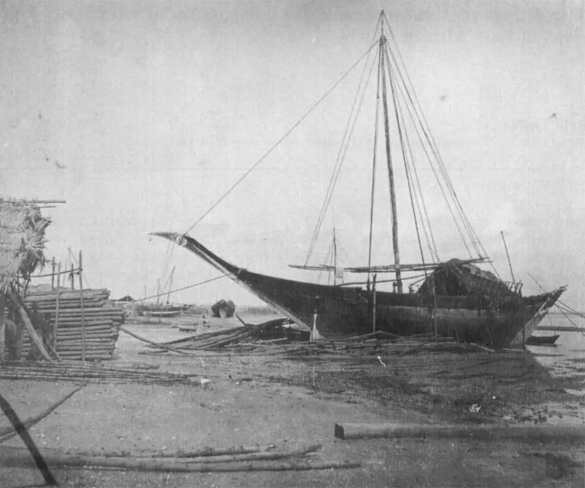Coir-sewn mtepe craft on the beach at Zanzibar, circa 1890. Note the mangrove poles stacked on the beach and next to the ship.