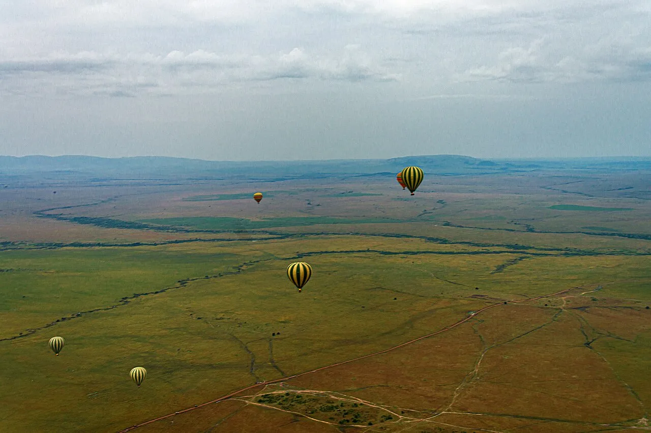 View of other balloons from balloon on Maasai Mara aerial safari. Hills in background are in Serengeti National Park in neighboring Tanzania