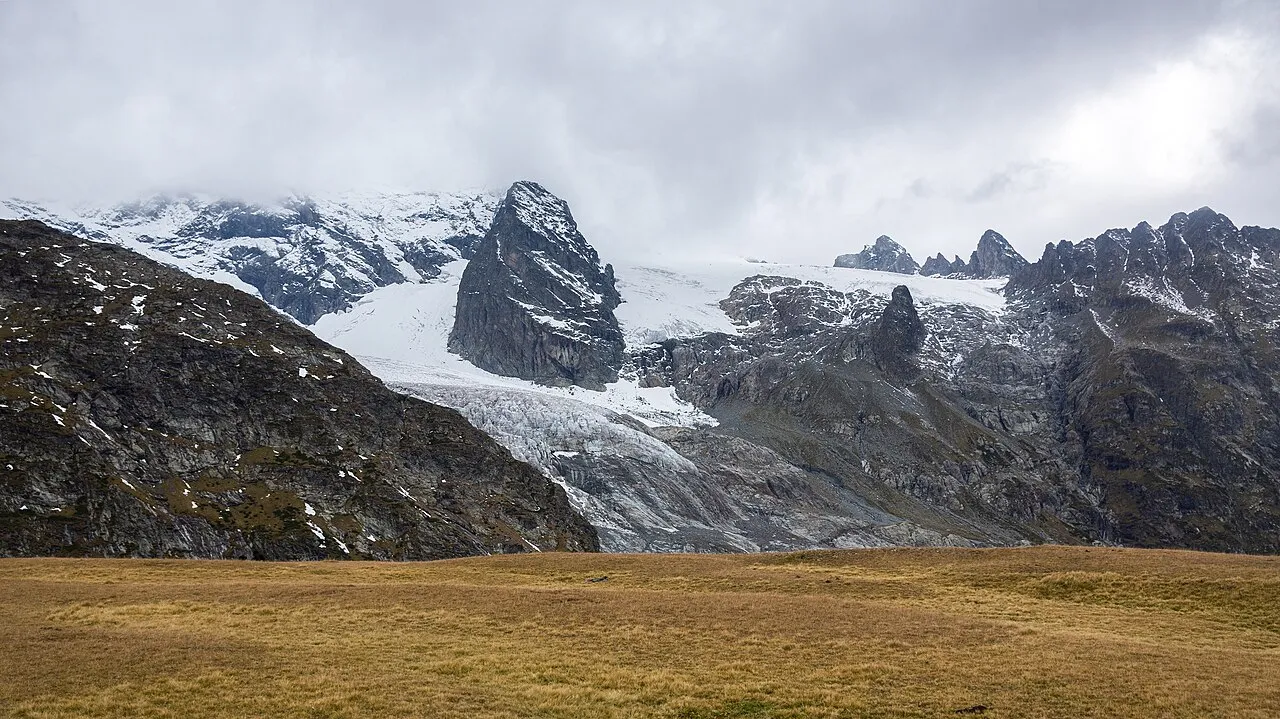 Sofia Massif (3,637 metres (11,932 ft)) and Sofia Glacier in clouds and fog under fresh autumn snow. Karachay-Cherkessia, Caucasus Mountains.